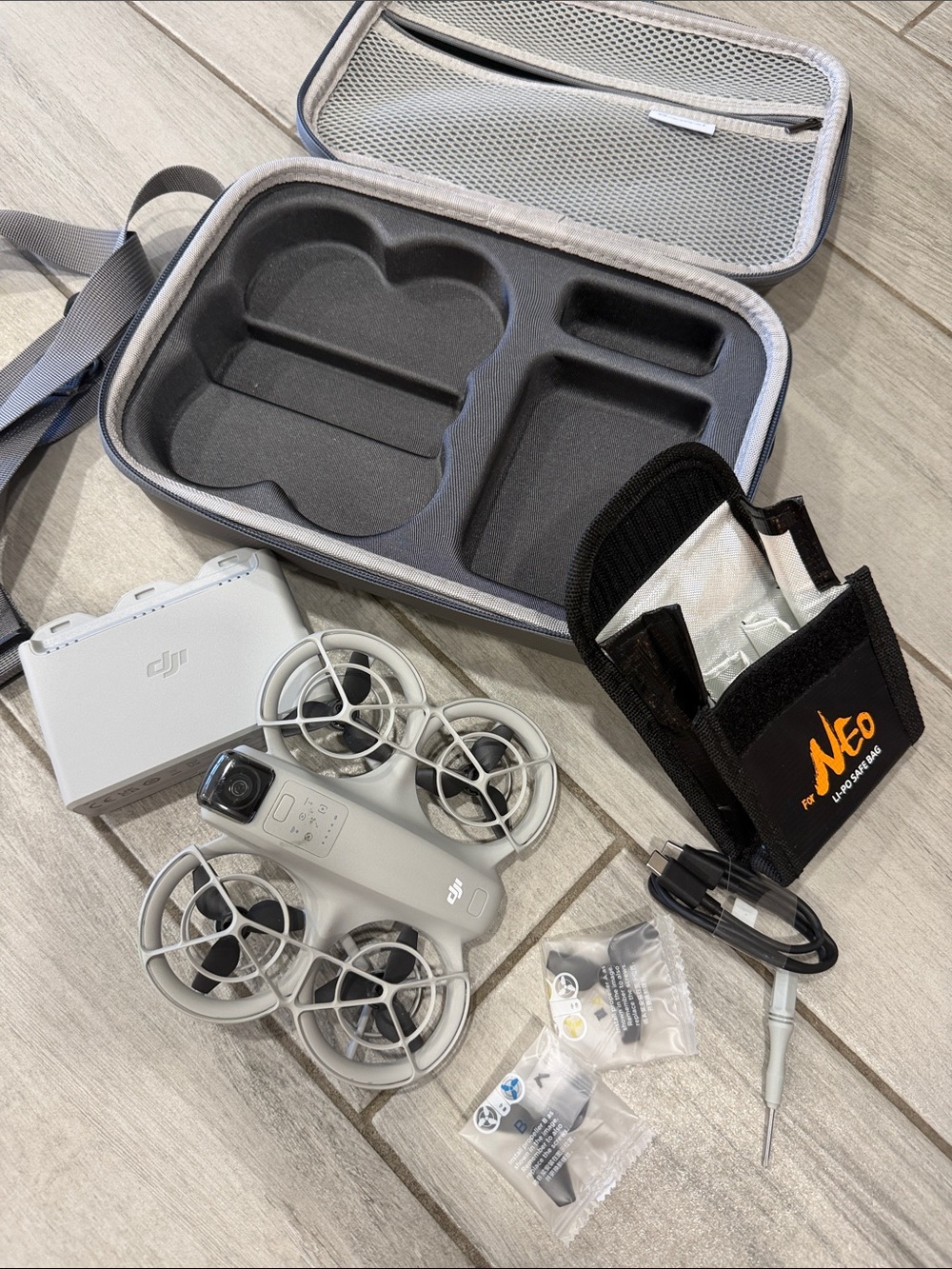 DJI White Mini Drone with Gray Carry Case and Black Accessory Pouch